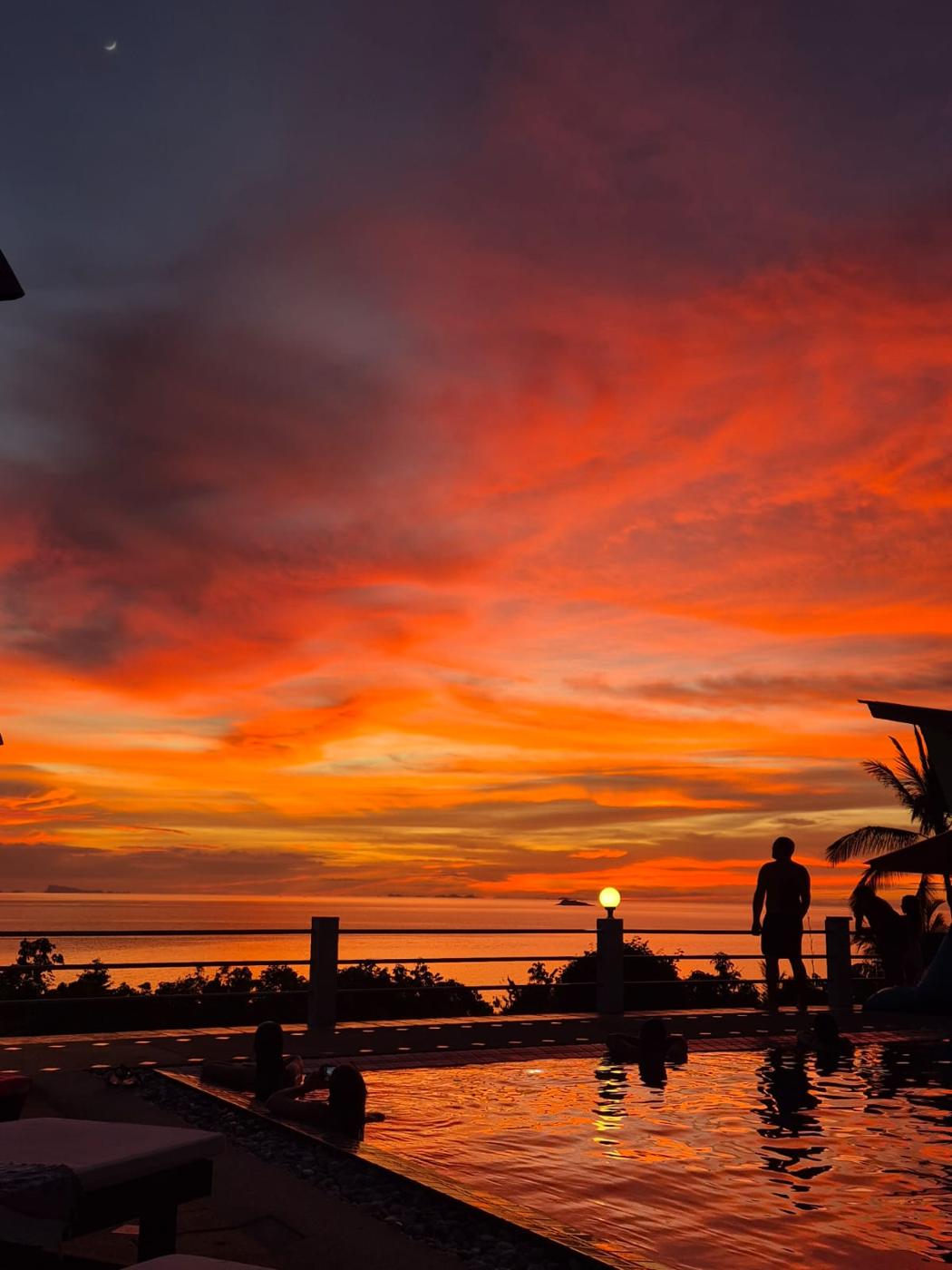 Red sky over the pool deck at dusk