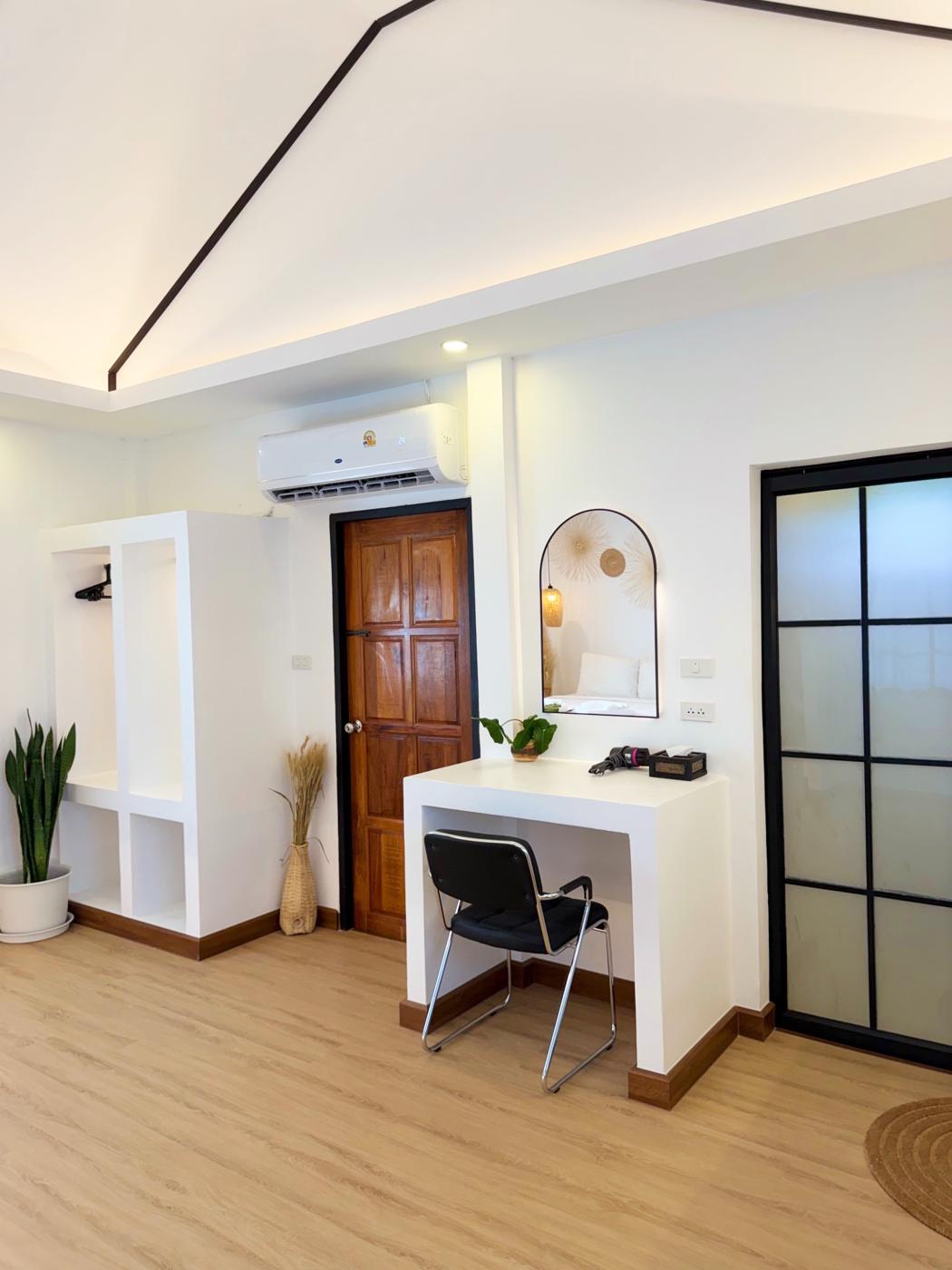 Desk with arched mirror, open wardrobe and air-con