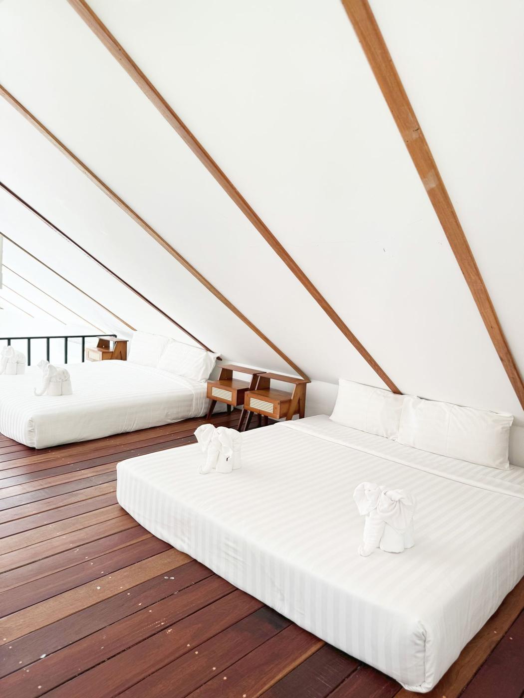 Gallery bedroom under the roof beams with two king beds