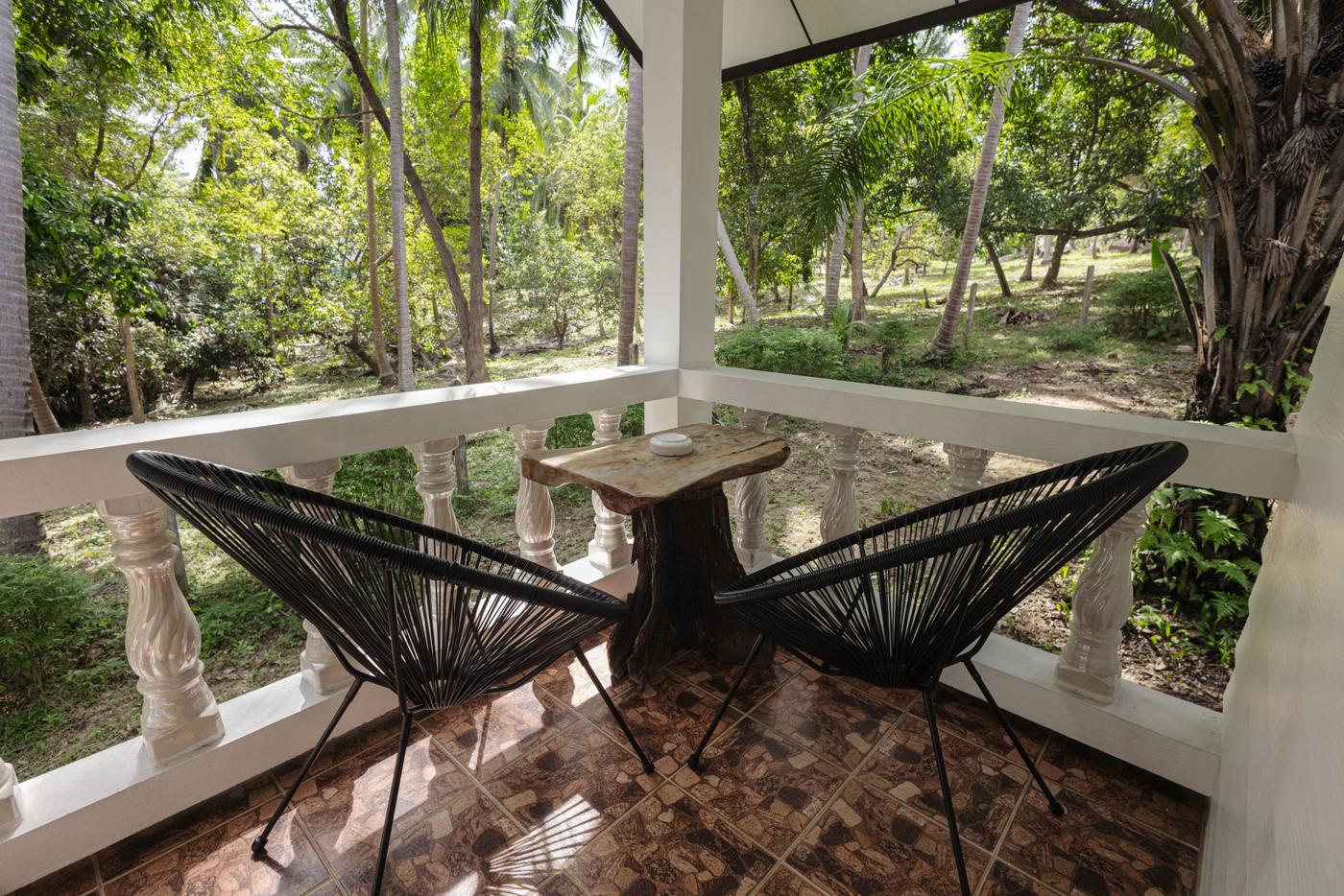 Porch with two chairs looking into the garden