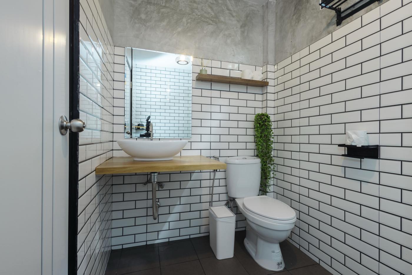 Bathroom with white subway tiles and vessel sink