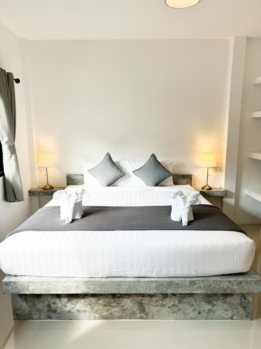 Downstairs bedroom with king bed and bedside lamps