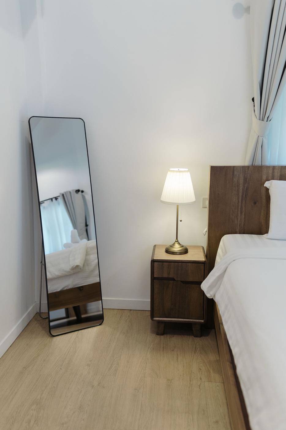 Bedside table with lamp and standing mirror